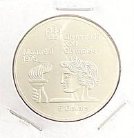 Reverse side of coin showing Montreal 1976 Olympic torch design and denomination