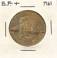 Obverse of 1983 Nova Scotia Trade Dollar showing coat of arms in holder labeled E.F.+