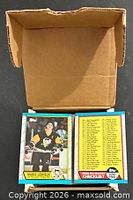 Stack of 1989-90 Topps hockey cards in open box, Mario Lemieux card on top