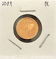 Reverse of 2009 Canadian proof 1-cent coin showing maple leaves, in holder