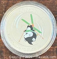 Reverse of coloured Vancouver 2010 Olympic mascot 50-cent coin in capsule