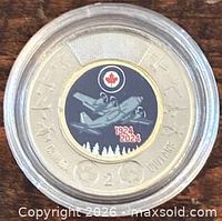 Reverse side of colourized 2024 RCAF toonie in capsule