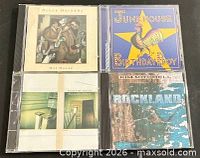 Front covers of the four CD jewel cases