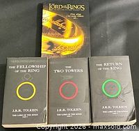 Front covers of four books including trilogy and additional ring-cover book