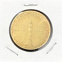 Obverse of brass token showing Alan Shepard and mission inscriptions