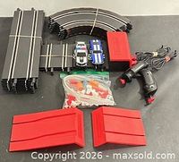 full lot overview showing track sections, cars, controller, power unit, accessories