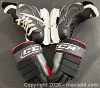 Pair of Reebok skates and CCM gloves together