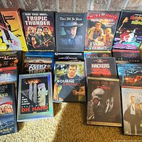 Overview of all DVD cases arranged on carpet against brick hearth