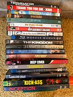 Stacked view of DVD spines showing 18 titles