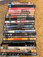 Full stack of DVD and Blu-ray cases showing titles on spines