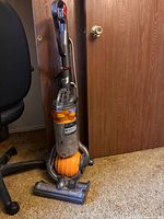 Full view of Dyson DC25 upright vacuum standing