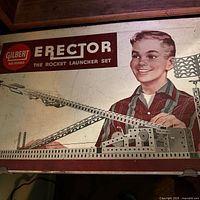 Lid of metal case showing Gilbert Erector The Rocket Launcher Set No. 10053 graphics