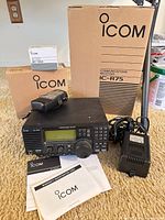 Front view of IC-R75 receiver with AC adapter, IC-R3 handheld, manuals and both boxes