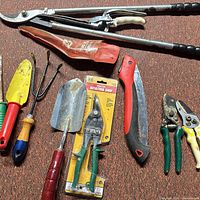All nine garden hand tools laid out