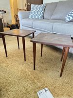 Both square MCM tables shown beside sofa