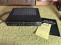 Amplifier with manual and receipt on carpet