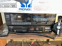Front view of TEAC cassette deck, Pioneer CD changer, remote, headphones, partial Pioneer box visible