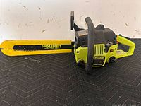 Full view of Poulan chainsaw showing bar, body and handles