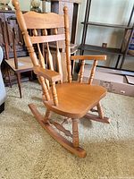 Full view of wooden rocking chair showing arms, backrest, runners and overall finish