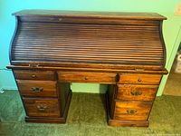 Front view of wood roll-top desk closed
