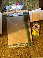Overview showing Carl RT-200 trimmer, ruler, protractor, index cards, envelopes, screen cleaner