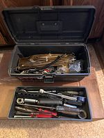 Toolbox open with lid showing tray and tools inside and below