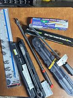 Overview showing all torque wrenches, cases, serpentine belt tool packaging, pry bars