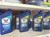 Shelf view of eight Valvoline transmission fluid bottles