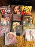 Group shot of all compact discs in lot