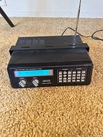 Front view showing display, knobs, keypad and antenna