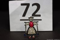 Front view of Dutch girl brooch with rhinestones and colored stones