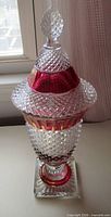 Full view of lidded diamond point compote showing cranberry flash band and square pedestal