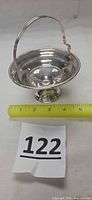Full view of sterling pedestal candy dish with ruler for scale