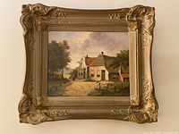 Front view of framed oil painting showing artwork and ornate frame