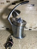 Full view of Breville Citrus Press Pro juicer showing lever arm, cone, cord