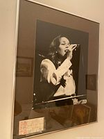 Framed black & white photo with ticket stub visible