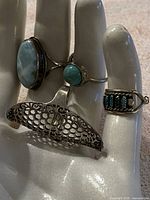 Four rings on display hand showing overall lot