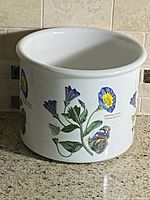 Front view of planter showing floral and butterfly design