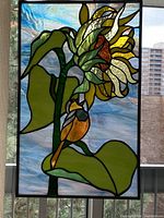 Full view of stained glass panel against window