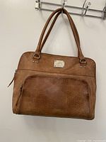 Front view of tan Velez leather handbag with handles and exterior zip pocket