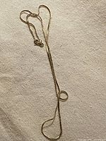 Full view of gold box chain laid out