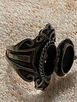 Ring with locket open showing interior compartment and ornate shank