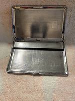 Case open showing interior texture and retaining bar