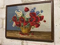 Full view of framed needlepoint hanging on wall