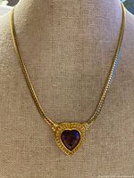 Full view of necklace on display bust showing pendant and chain