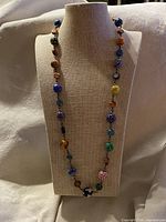 Full view of the necklace displayed on bust showing length and bead arrangement