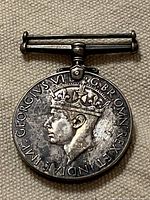 Obverse showing King George VI portrait and suspension bar