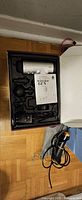 Massage gun kit in box with attachments and manual visible