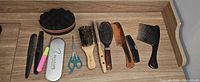 All eleven hair-grooming items arranged on wooden surface