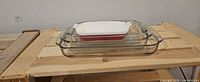Stack of four rectangular baking dishes showing materials and sizes